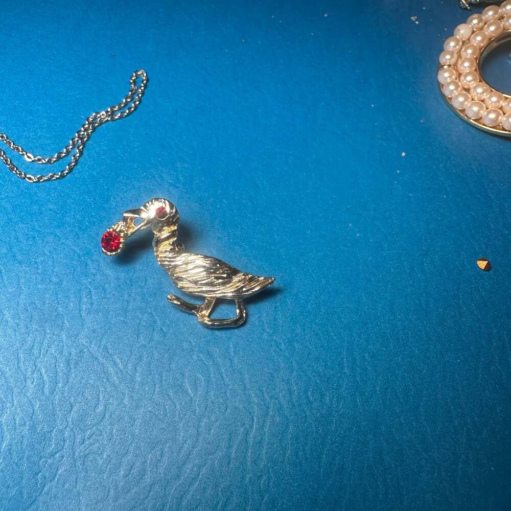 Vintage Gold Tone Pelican Brooch with Red Rhinestone Eye